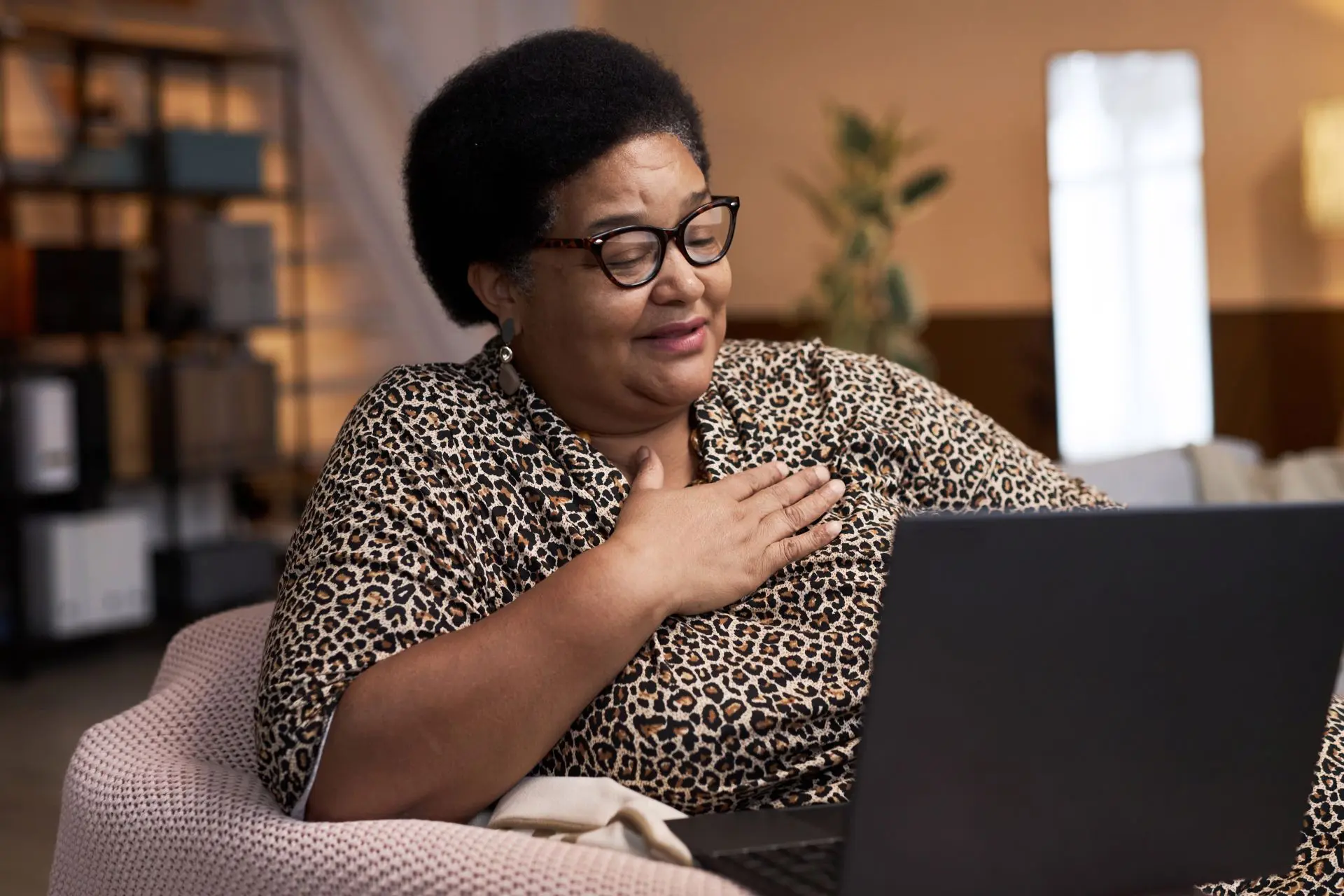 Woman reading information on laptop with a look of relief